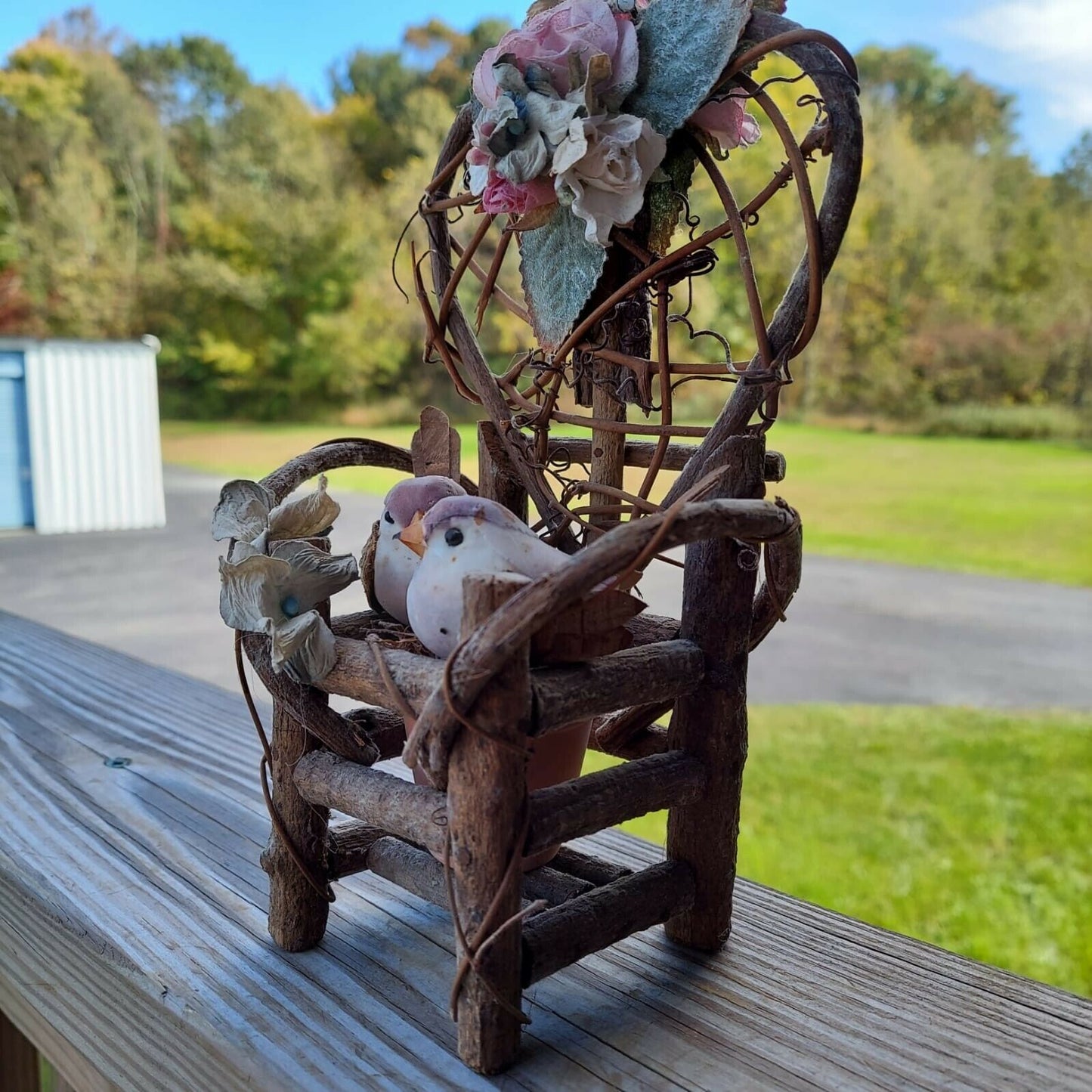 miniature wood garden chair with two birds on it