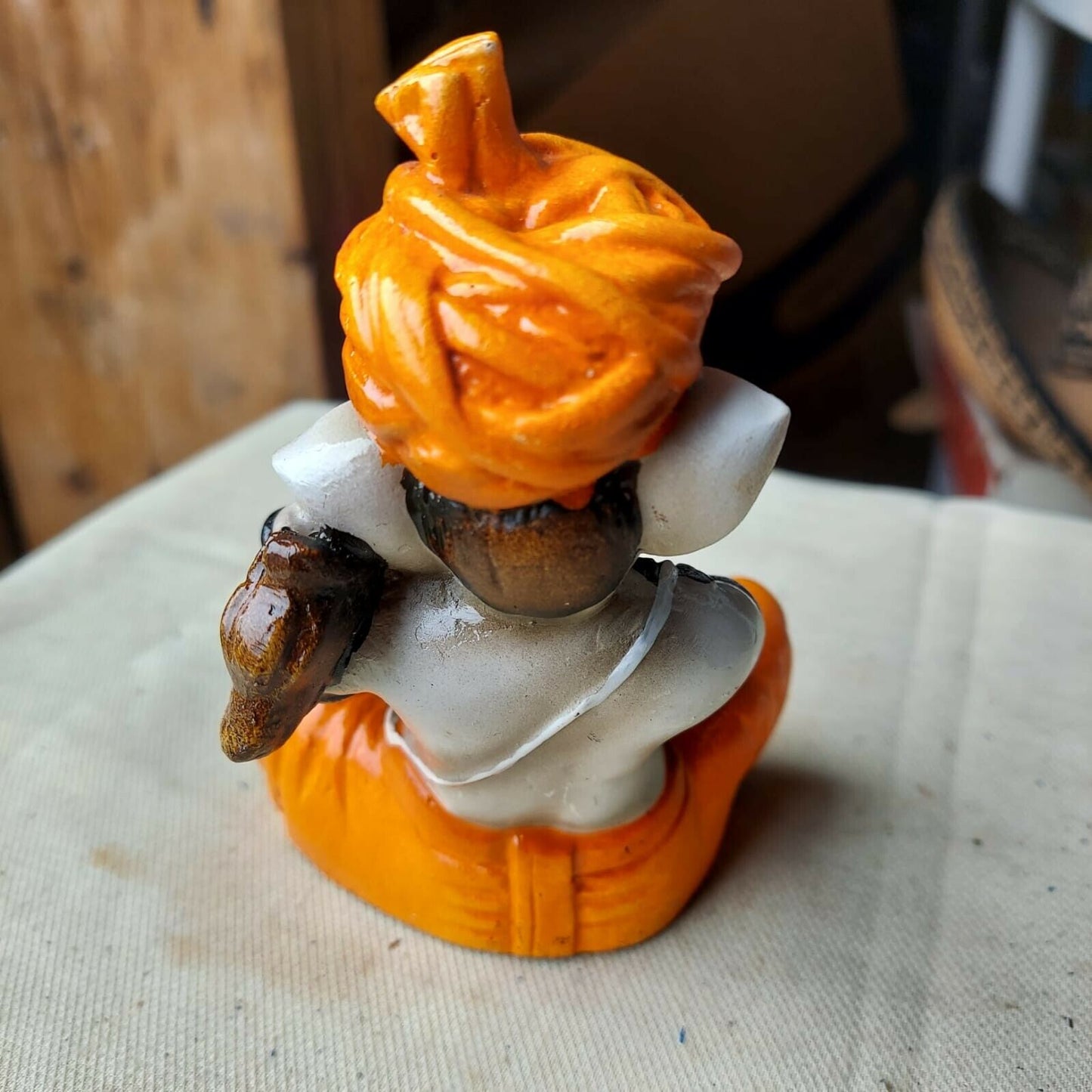 Karigaari India Karigaari Polyresine Ganesha Playing Instrument Orange Figurine