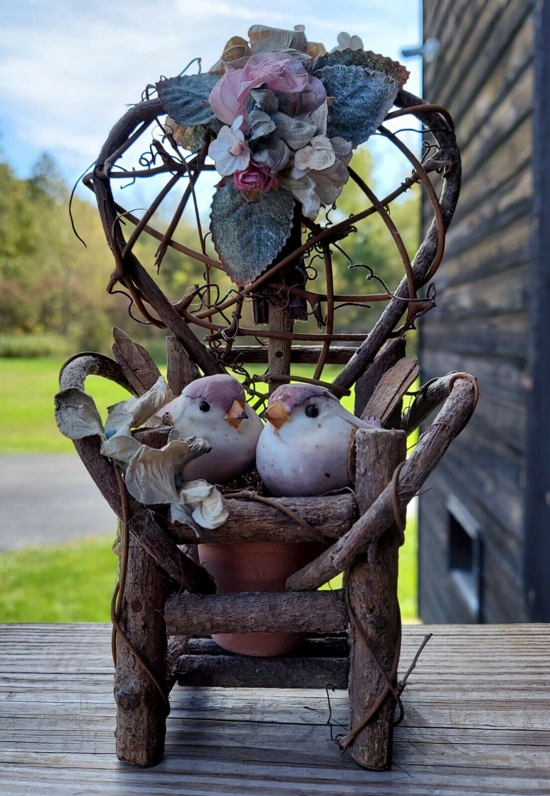 miniature wood garden chair with two birds on it