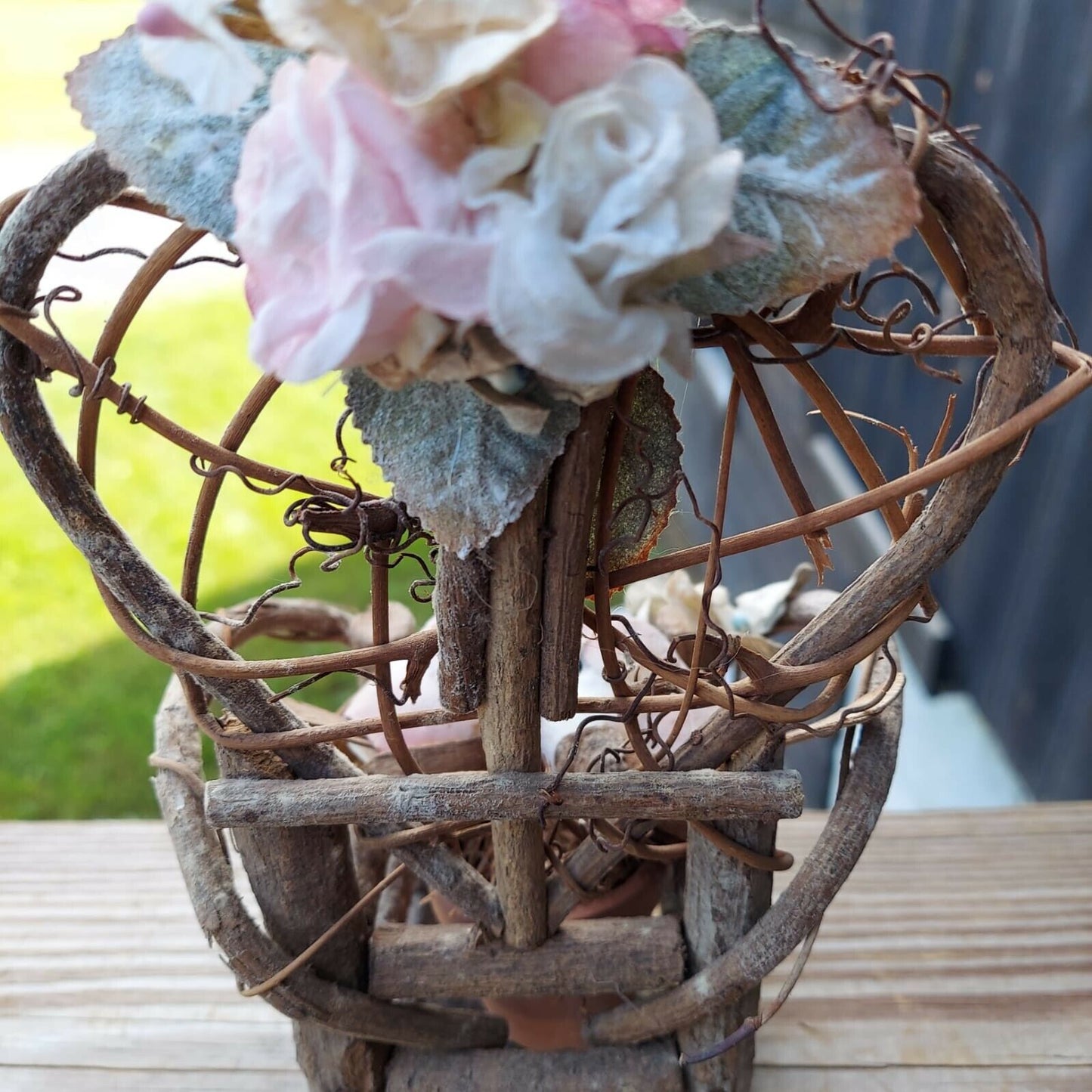 miniature wood garden chair with two birds on it