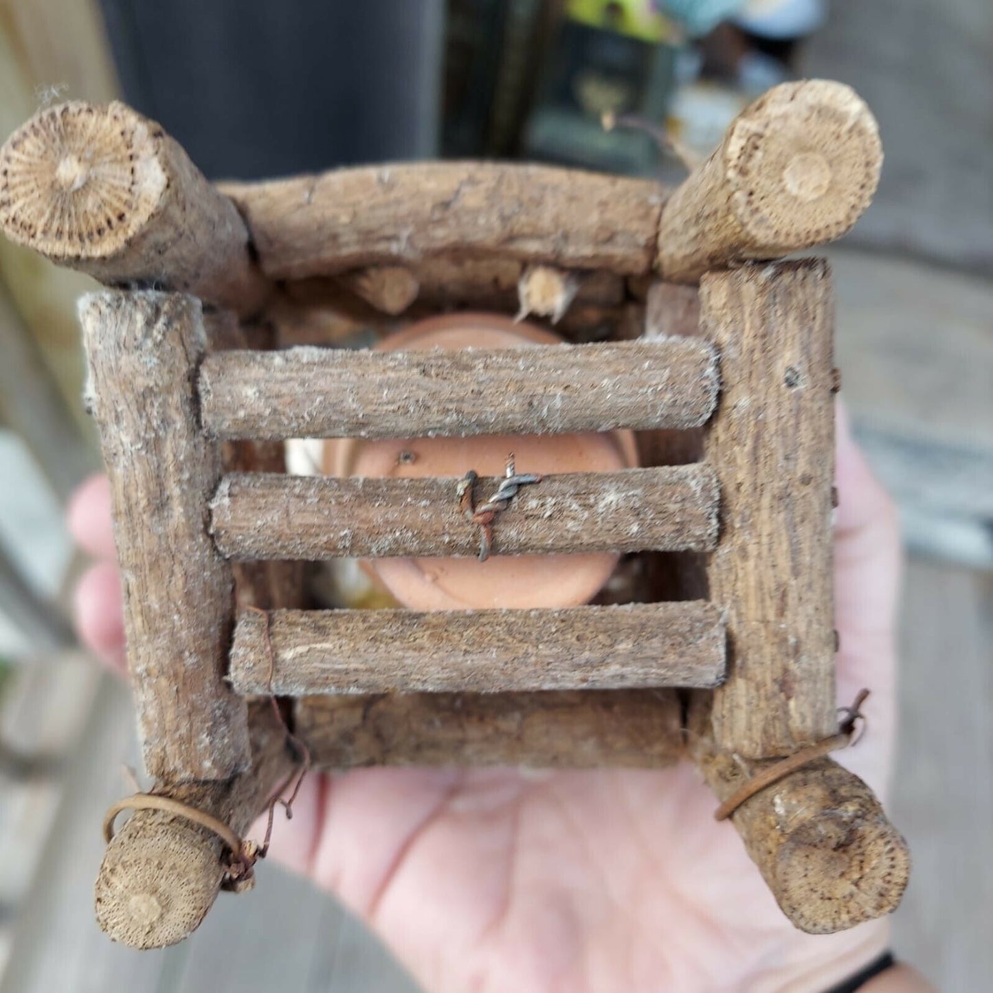 miniature wood garden chair with two birds on it