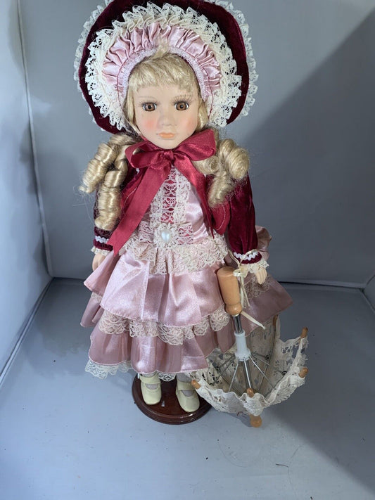 vintage victorian porcelain doll original clothing and umbrella.