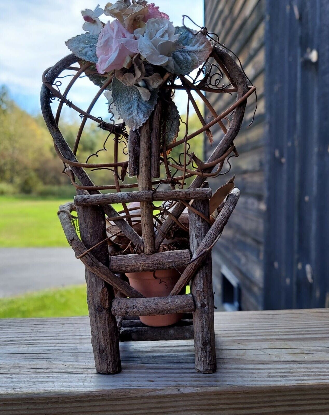 miniature wood garden chair with two birds on it