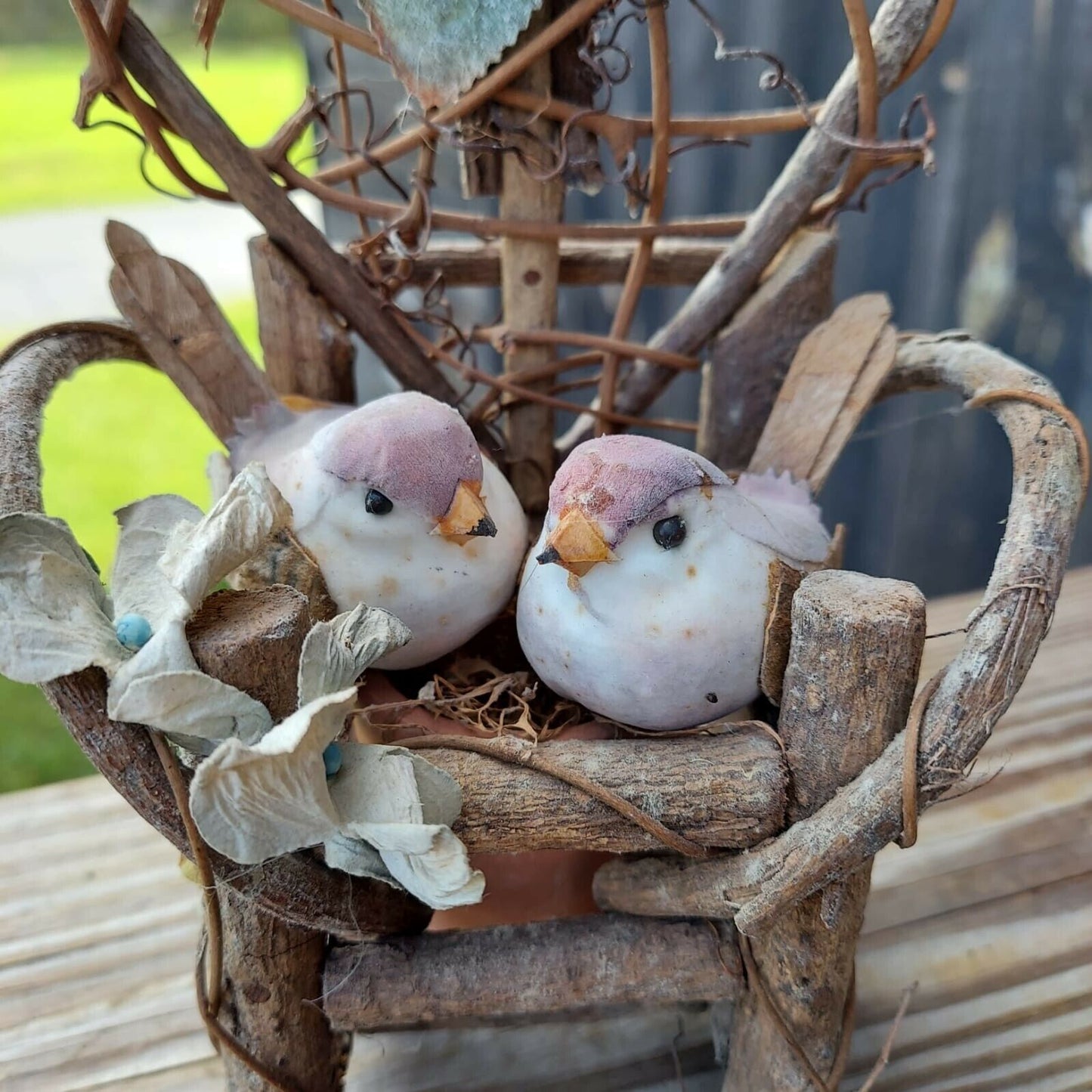 miniature wood garden chair with two birds on it